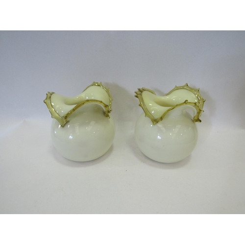 1244 - A pair of yellow glass bulbous form vases, 14cm tall