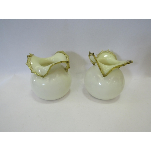 1244 - A pair of yellow glass bulbous form vases, 14cm tall