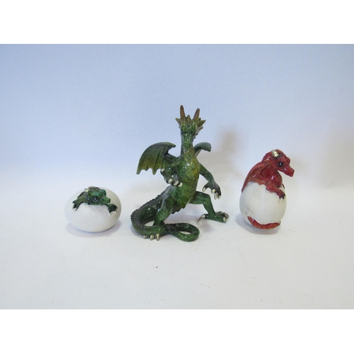 1273 - A ceramic green standing dragon 12cm tall, and two others hatching from eggs