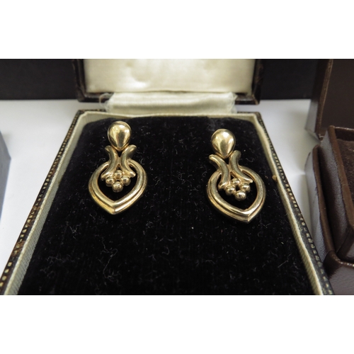 7066 - Three pairs of 9ct gold earrings including two pairs set with a small diamond, 6.8g