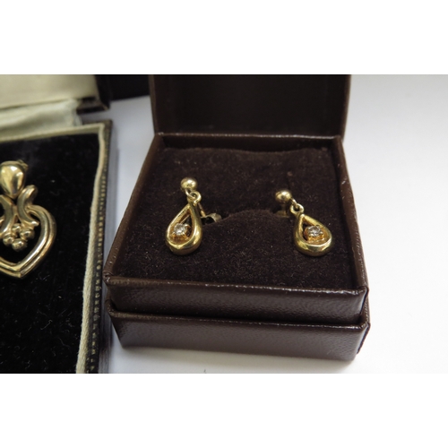 7066 - Three pairs of 9ct gold earrings including two pairs set with a small diamond, 6.8g