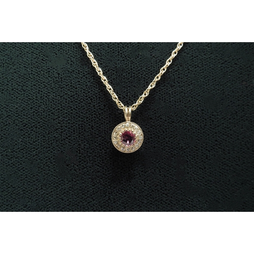 7093 - A ruby and diamond pendant hung on gold chain, stamped 9ct, 44cm long, 2.7g