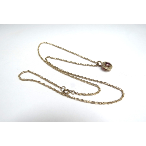 7093 - A ruby and diamond pendant hung on gold chain, stamped 9ct, 44cm long, 2.7g