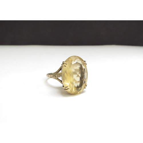 7091 - A 9ct gold ring with an oval citrine, 18mm x 12mm. Size N, 5g