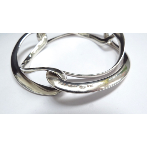 7098 - A Georg Jensen silver Infinity bangle by Regitze Overgaard #452, 57.7g, boxed