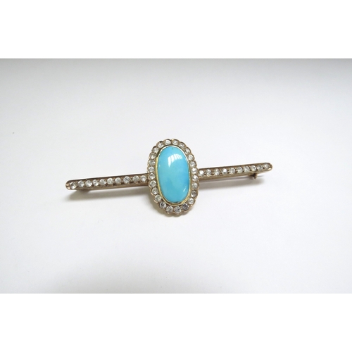 7411 - A large bar brooch with central oval framed and flanked by white topaz, unmarked, 7cm long, 7.5g