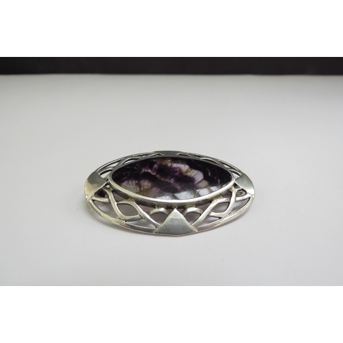 7413 - An oval silver brooch with central Blue John panel, 5cm x 3.3cm, 10.8g