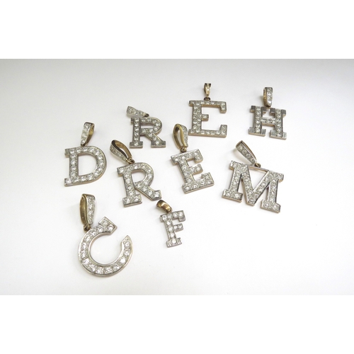 7070 - Nine 9ct gold charms as letters 