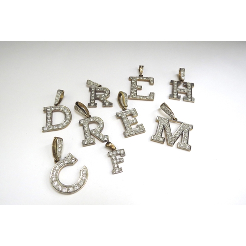 7070 - Nine 9ct gold charms as letters 