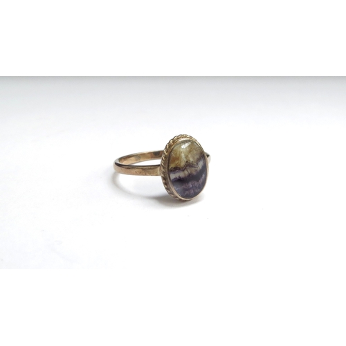 7412 - A 9ct gold ring set with an oval Blue John cabochon. Size N, 2.4g  - RE-OFFER IN NEXT JEWELLERY