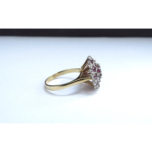 7020 - An 18ct gold ruby and diamond cluster ring. Size N/O, 5.4g         (C)
