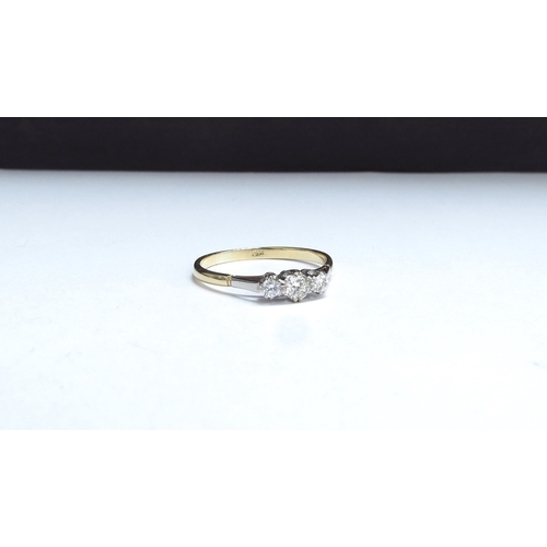 7004 - A three stone diamond ring, stamped 18ct. Size W/X, 2.6g