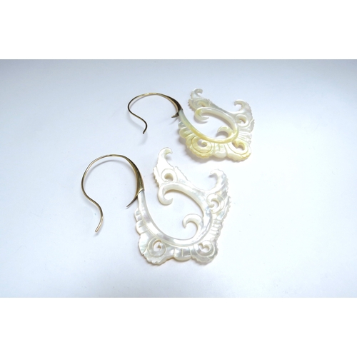 7074 - An ornate pair of carved mother-of-pearl earrings   (C)