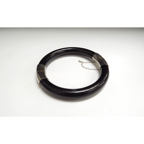 7094 - A black jade bracelet, 6cm diameter