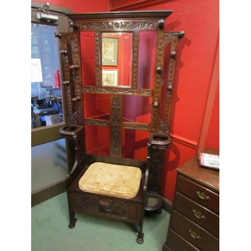 4089 - A late Victorian carved oak hall/stick stand with twelve turned hanging pegs, the box seat settle wi... 