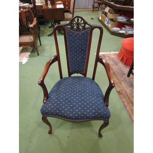 4102 - An Edwardian carved mahogany armchair, the blue upholstered serpentine front seat over cabriole fore... 