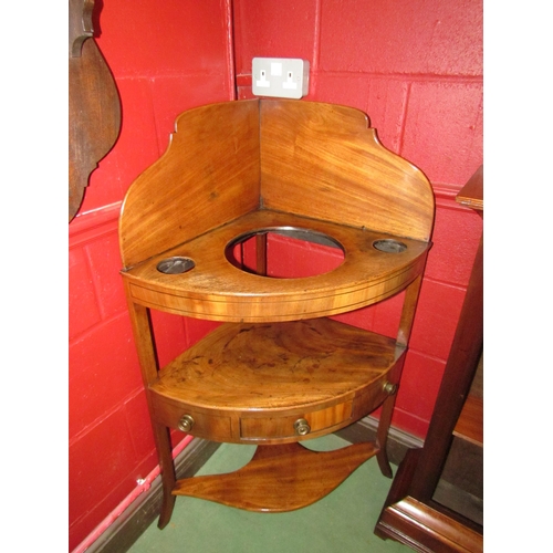 4167 - A George III flame mahogany three tier corner washstand, the raised back over a central single drawe... 