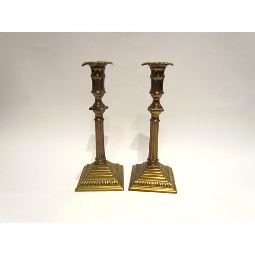 4188 - A pair of Georgian brass column candlesticks, 26cm tall