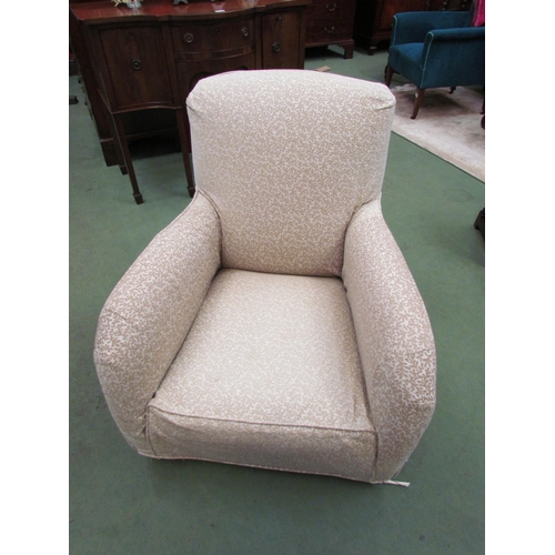 4210 - A Circa 1920 rounded armchair on castors with removable loose cover  (R)  £50