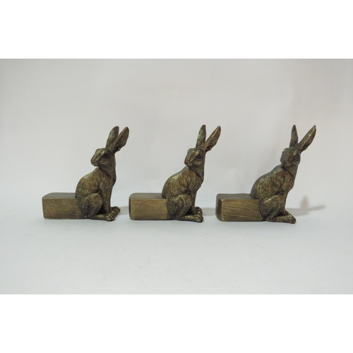 4528 - A set of three resin bronze hare plant pot feet, 9cm tall