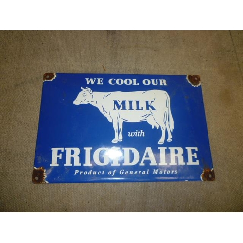 6138 - A reproduction 'We cool our milk with Frigidaire, product of General Motors' enamel sign 30cm x 20cm