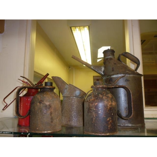 6153 - Four oil cans and an oil jug