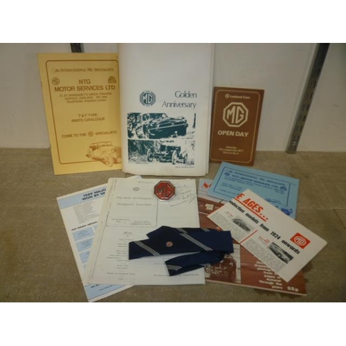 6168 - An MG Golden Anniversary folder containing an MG tie, chromed MG badge along with various ephemera