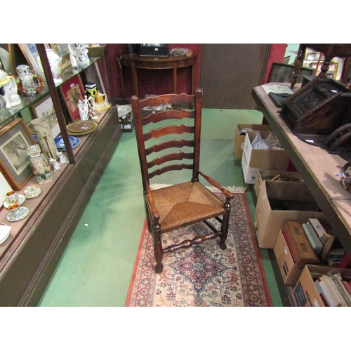 4216 - A Circa 1800 oak six rung ladder back North Country low rush seat armchair on pad foot, turned fore ... 