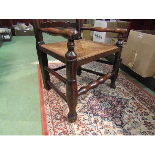 4216 - A Circa 1800 oak six rung ladder back North Country low rush seat armchair on pad foot, turned fore ... 