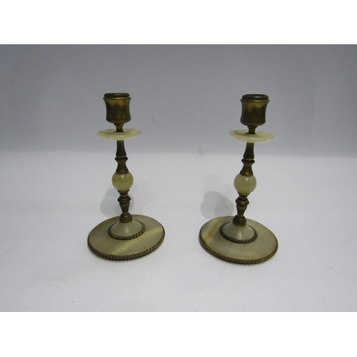 4229 - A pair of brass and onyx candlesticks, 20cm tall