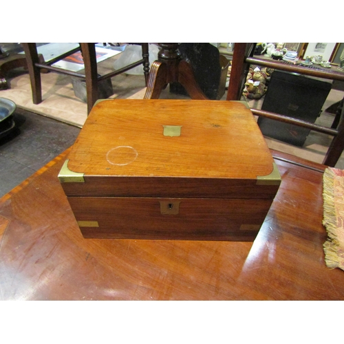 4232 - A mahogany brass mounted writing slope, brass cartouche and escutcheon  (R)  £20