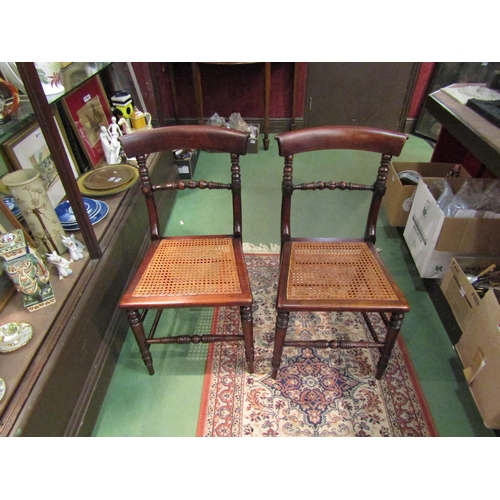 4249 - A pair of early Victorian ash and elm cane seat chairs with turned and fluted central bar back on tu... 