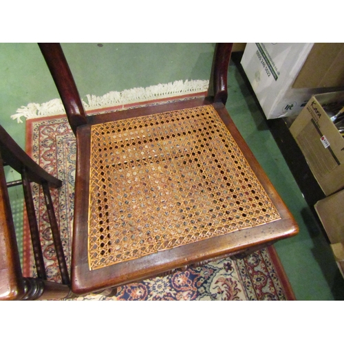 4249 - A pair of early Victorian ash and elm cane seat chairs with turned and fluted central bar back on tu... 