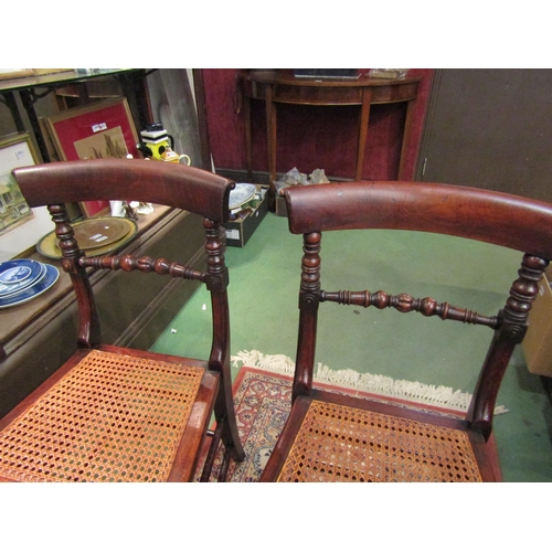 4249 - A pair of early Victorian ash and elm cane seat chairs with turned and fluted central bar back on tu... 