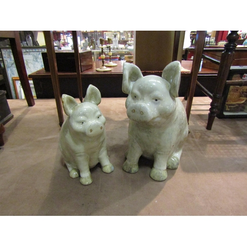 4258 - Two large pottery pigs, 32cm and 27cm tall