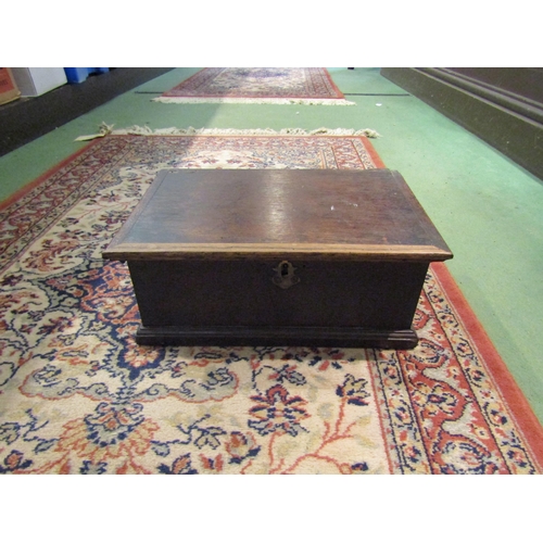 4261 - An oak box, brass escutcheon, plinth base, (lid loose) 34cm long x 22cm wide x 14cm deep     (R) £30