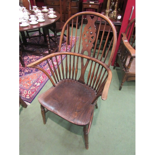 4068 - A 19th Century oak Windsor chair with wheel-back on 