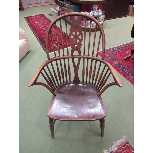 4068 - A 19th Century oak Windsor chair with wheel-back on 