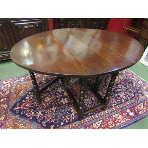 4071 - An 18th Century oak oval top gate-leg dining table, the rising leaves over a single end drawer on bo... 