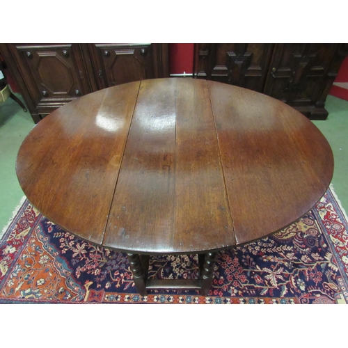 4071 - An 18th Century oak oval top gate-leg dining table, the rising leaves over a single end drawer on bo... 