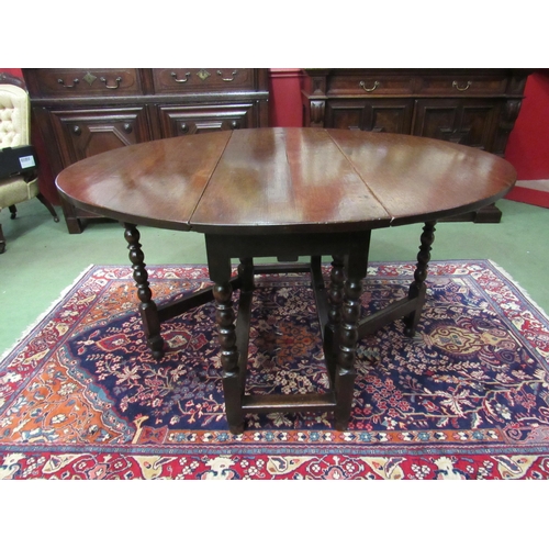 4071 - An 18th Century oak oval top gate-leg dining table, the rising leaves over a single end drawer on bo... 