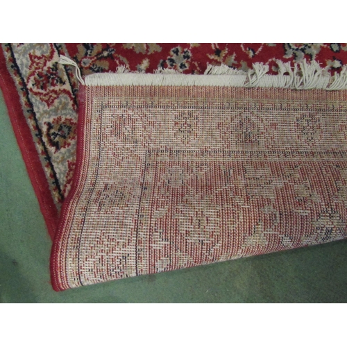 4076 - A small black and gold rug with foliate design and tasselled ends, 135cm x 69cm, together with a red... 