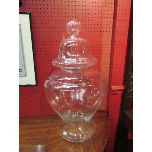 4083 - A clear glass lidded chemist jar, 60cm tall