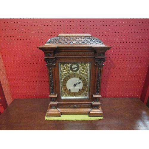 4097 - A Mahogany Elkington & Co. bracket clock, carved case and column form front, ornate decoration to fa... 