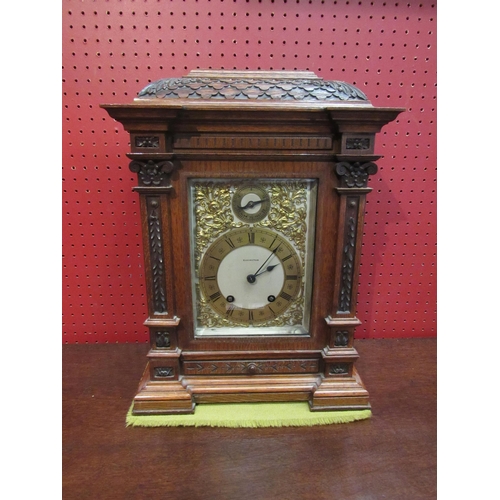 4097 - A Mahogany Elkington & Co. bracket clock, carved case and column form front, ornate decoration to fa... 