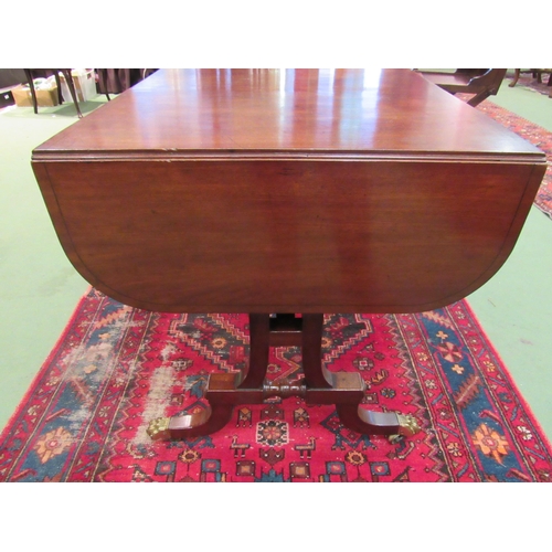 4108 - A Regency flame mahogany country house sofa table with black line inlay, the rising leaves over two ... 