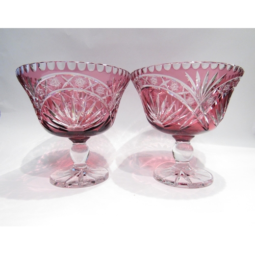 4159 - A pair of ruby flash cut glass comports, bolbous stem, star cut base, 25cm diameter