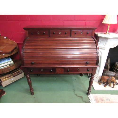 4172 - An early Victorian mahogany roll top desk, the three raised drawers over a tambour front (locking ke... 