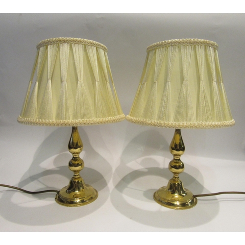 4177 - A pair of brass table lamps with silk strung cream shades