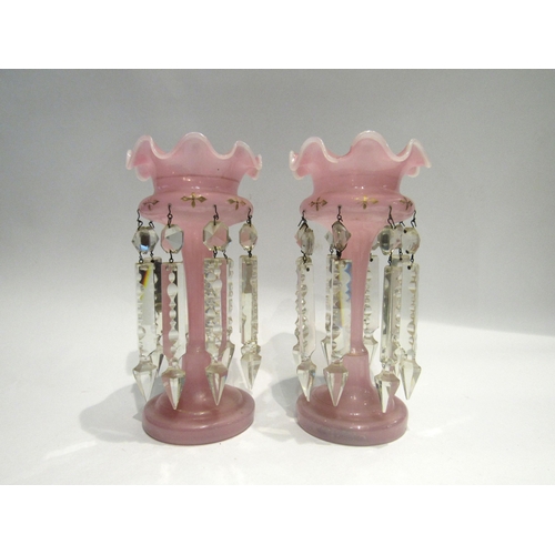 4178 - A pair of pink glass lustres, wavy rim, 25cm tall, gilt highlights